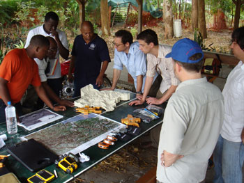 photo showing meeting betwee Haiti Regeneration Initiatiative Project Partners and local people using topographical model to demonstrate project objectives