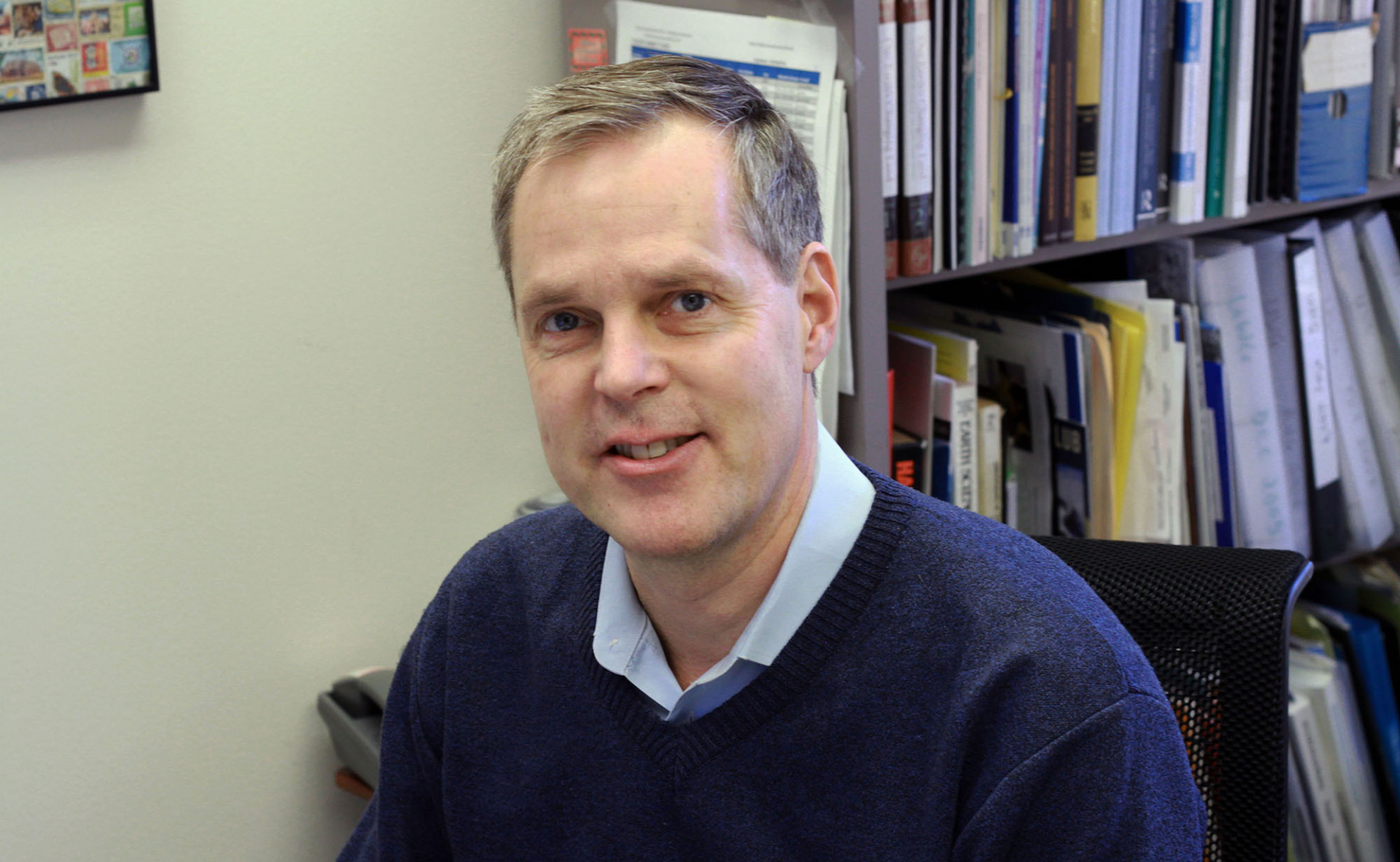 Alexander DeSherbinin is named new director of the Center for International Earth Science Information Network (CIESIN). Photograph of new CIESIN director Alex de Sherbinin sitting at his desk.